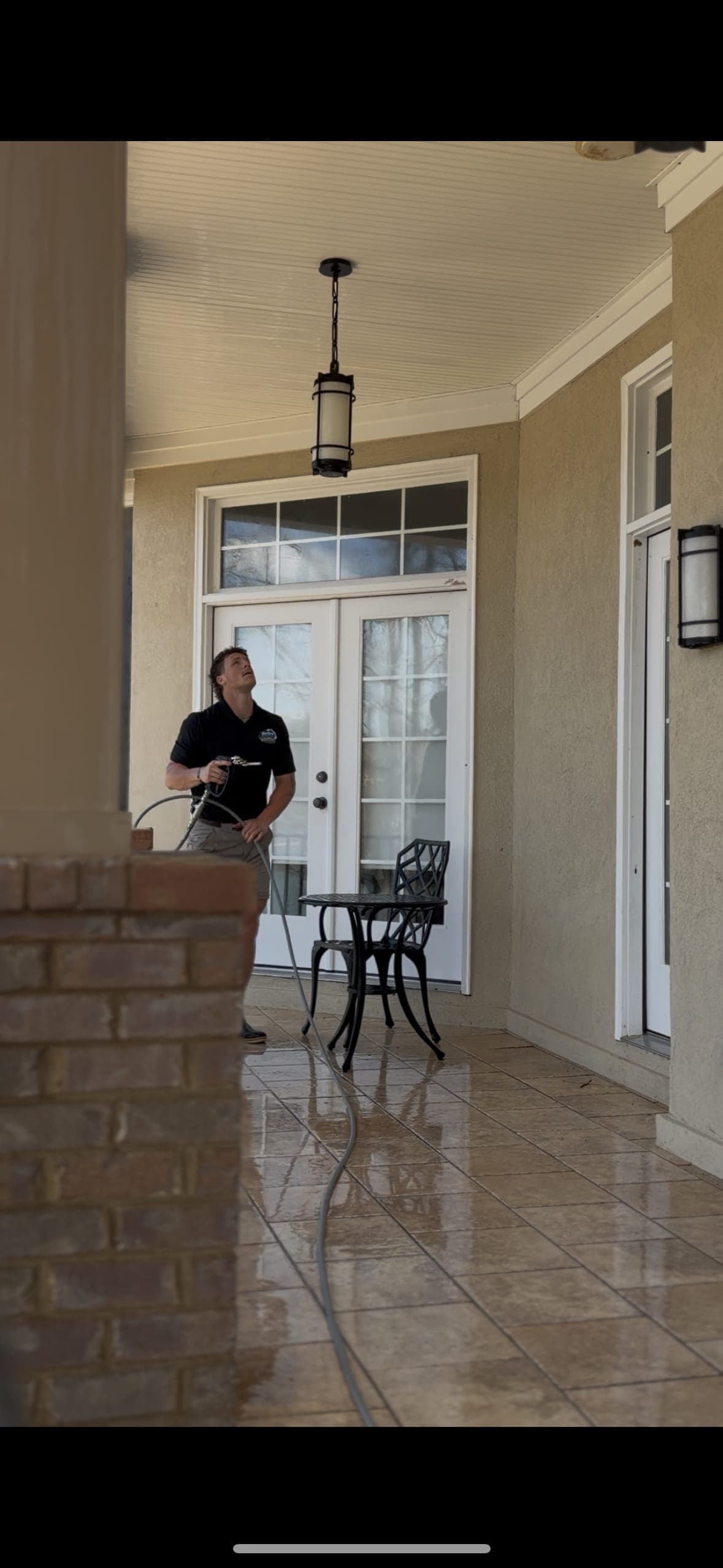 Technician standing on a freshly cleaned porch at a Chapin, SC home